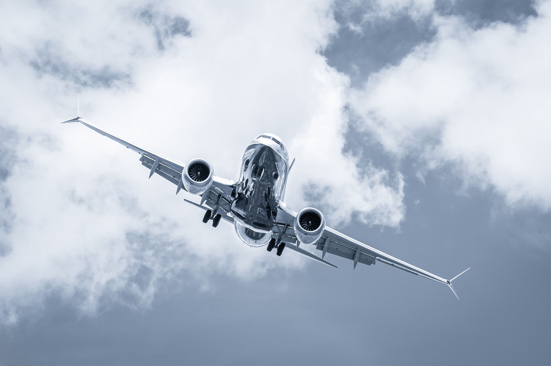 blue toned cross-wind passenger jet landing